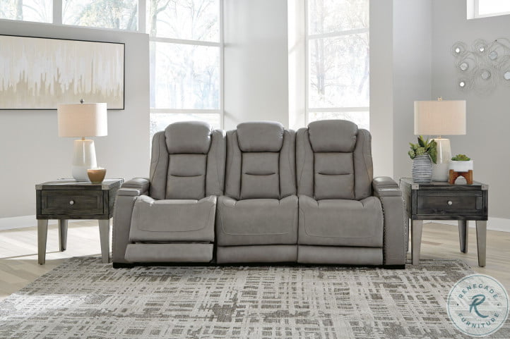Leather power reclining sofa with adjustable headrest store